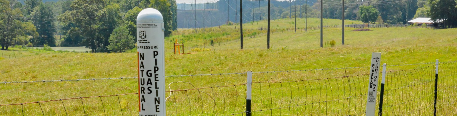 Natural gas pipelines markers in a field